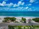 Beautiful beach aerial, featuring ocean views, a quiet road, and lush vegetation offering an idyllic coastal setting at 3630 Gulf Of Mexico Dr # 202, Longboat Key, FL 34228