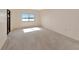 Bright bedroom with carpet flooring, lake views from a large window, and ample natural light at 3630 Gulf Of Mexico Dr # 202, Longboat Key, FL 34228