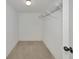 Bright walk-in closet with carpeted floor and wire shelving for optimal storage and organization at 3630 Gulf Of Mexico Dr # 202, Longboat Key, FL 34228