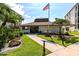 Well-maintained clubhouse featuring manicured landscaping, a fountain, and sidewalk at 3630 Gulf Of Mexico Dr # 202, Longboat Key, FL 34228