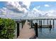 Wooden dock extending into the water with boat slips and waterfront views at 3630 Gulf Of Mexico Dr # 202, Longboat Key, FL 34228