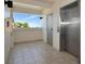 Hallway to stainless elevator with access to condo floors and a window offering a view at 3630 Gulf Of Mexico Dr # 202, Longboat Key, FL 34228