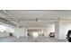 Bright, well-lit parking garage with visible piping, overhead lighting, and parking spaces at 3630 Gulf Of Mexico Dr # 202, Longboat Key, FL 34228