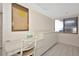 Bright kitchen area with a built-in desk, white cabinetry, and tile flooring creating a functional and tidy workspace at 3630 Gulf Of Mexico Dr # 202, Longboat Key, FL 34228