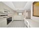 Eat-in kitchen with bright tile floors, white appliances, ample cabinets and a large opening to another living space at 3630 Gulf Of Mexico Dr # 202, Longboat Key, FL 34228
