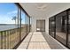 Relaxing enclosed lanai with tiled floor and beautiful views through the large sliding glass doors at 3630 Gulf Of Mexico Dr # 202, Longboat Key, FL 34228