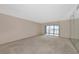 Carpeted living room with sliding glass doors to a lanai at 3630 Gulf Of Mexico Dr # 202, Longboat Key, FL 34228
