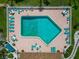 Overhead shot of a community pool with many lounge chairs and manicured landscaping at 3630 Gulf Of Mexico Dr # 202, Longboat Key, FL 34228