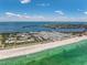 Coastal real estate featuring a waterfront community with beach access, clear turquoise waters, and manicured landscape at 3806 Gulf Of Mexico Dr # C204, Longboat Key, FL 34228