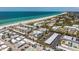 Scenic aerial view of a coastal community featuring beautiful beaches, a large parking area, and mature landscaping at 3806 Gulf Of Mexico Dr # C204, Longboat Key, FL 34228