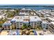 Waterfront condo complex with a pool, private beach access, and lush landscaping on the water at 3806 Gulf Of Mexico Dr # C204, Longboat Key, FL 34228