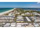 Picturesque aerial view of a coastal community with beautiful beaches, a nearby marina, and lush landscaping throughout at 3806 Gulf Of Mexico Dr # C204, Longboat Key, FL 34228