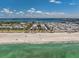 Beautiful beachside community with turquoise waters and a pristine sandy beach under a sunny blue sky at 3806 Gulf Of Mexico Dr # C204, Longboat Key, FL 34228