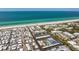 Aerial view of a beach community with various condos, a white sand beach, and clear turquoise water at 3806 Gulf Of Mexico Dr # C204, Longboat Key, FL 34228