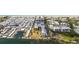 Aerial view of a waterfront condo complex with boat docks, pool, landscaping and a beautiful white sand beach beyond at 3806 Gulf Of Mexico Dr # C204, Longboat Key, FL 34228