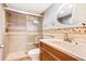 Tiled bathroom featuring a glass shower and vanity with a marble countertop at 3806 Gulf Of Mexico Dr # C204, Longboat Key, FL 34228