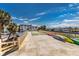 An elevated common area with shuffleboard and kayaks, with palm trees and blue skies at 3806 Gulf Of Mexico Dr # C204, Longboat Key, FL 34228