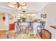 Open concept dining area with chairs, glass table and ornate chandelier providing an airy and inviting atmosphere at 3806 Gulf Of Mexico Dr # C204, Longboat Key, FL 34228