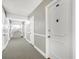 Clean, well-lit condo hallway with neutral colors leading to unit 204 at 3806 Gulf Of Mexico Dr # C204, Longboat Key, FL 34228