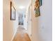 Hallway with ceramic tile flooring that is naturally lit and connects the living space to other areas at 3806 Gulf Of Mexico Dr # C204, Longboat Key, FL 34228