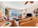 Comfortable living area with furniture, tile flooring, plants, and view of the water from the large windows at 3806 Gulf Of Mexico Dr # C204, Longboat Key, FL 34228