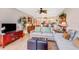 Open concept living area with tile floors, comfortable seating, and decor with a view into the kitchen at 3806 Gulf Of Mexico Dr # C204, Longboat Key, FL 34228