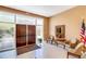 Condo lobby featuring an exit door with a large glass window, seating, decorations, and an American flag at 3806 Gulf Of Mexico Dr # C204, Longboat Key, FL 34228