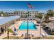 Community pool with ample seating, lounge chairs, and clubhouse amenities for residents to enjoy at 3806 Gulf Of Mexico Dr # C204, Longboat Key, FL 34228