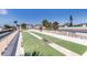 Outdoor shuffleboard courts with palm trees and blue skies at this property at 3806 Gulf Of Mexico Dr # C204, Longboat Key, FL 34228