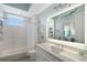 Stylish bathroom features a shower-tub combo, modern vanity, and under-cabinet lighting at 3921 Maravic Pl, Sarasota, FL 34231
