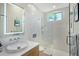 Modern bathroom featuring a walk-in shower with glass enclosure, floating vanity, and stylish fixtures at 3921 Maravic Pl, Sarasota, FL 34231