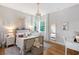 Charming bedroom boasts hardwood floors, accent lighting, and bright windows at 3921 Maravic Pl, Sarasota, FL 34231