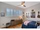 Well-lit bedroom features plantation shutters, hardwood floors, and decorative wall décor at 3921 Maravic Pl, Sarasota, FL 34231