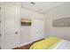 This bedroom features hardwood floors, a mounted TV and a double door closet at 3921 Maravic Pl, Sarasota, FL 34231