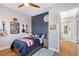Inviting bedroom features blue accent wall, hardwood floors, and hallway access at 3921 Maravic Pl, Sarasota, FL 34231