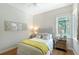 Cozy bedroom with a bright window, stylish decor, hardwood floors and mirrored bedside tables at 3921 Maravic Pl, Sarasota, FL 34231