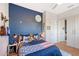 This bedroom has a unique space themed accent wall, mirrored closet, and a ceiling fan at 3921 Maravic Pl, Sarasota, FL 34231
