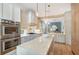 Modern kitchen with stone countertops, wood floors, stainless steel appliances and pendant lighting at 3921 Maravic Pl, Sarasota, FL 34231