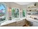 Bright kitchen sink area with stone countertops, natural light, and modern fixtures and lots of sunlight at 3921 Maravic Pl, Sarasota, FL 34231