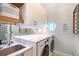 Efficient laundry room with modern washer, dryer, quartz countertop, and decorative tile at 3921 Maravic Pl, Sarasota, FL 34231