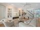 Inviting living room with fireplace, white sofa, built-in shelves, and open view to the entry at 3921 Maravic Pl, Sarasota, FL 34231