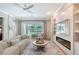 Bright living room features a fireplace, built-in shelves, and sliding glass doors to the backyard at 3921 Maravic Pl, Sarasota, FL 34231