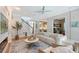 Inviting living room with staircase, desk, and open kitchen area with wood floors and light walls at 3921 Maravic Pl, Sarasota, FL 34231