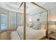 Comfortable main bedroom with four poster bed, light colors, tray ceiling, and access to the outside at 3921 Maravic Pl, Sarasota, FL 34231