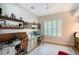 Well-lit office space with dual desks, wood shelving, and plantation shutters at 3921 Maravic Pl, Sarasota, FL 34231