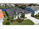 Aerial view of a well-maintained home with lush landscaping and lake view at 4257 Hearthstone Dr, Sarasota, FL 34238