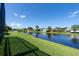 Scenic backyard view overlooking a serene lake, offering privacy and natural beauty at 4257 Hearthstone Dr, Sarasota, FL 34238