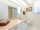 Bathroom with a granite countertop vanity and white cabinets at 4257 Hearthstone Dr, Sarasota, FL 34238