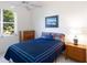 Comfortable bedroom with a colorful comforter set and a view of the pond at 4257 Hearthstone Dr, Sarasota, FL 34238