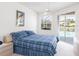 Bedroom with ceiling fan, and large sliding glass doors to pool area at 4257 Hearthstone Dr, Sarasota, FL 34238